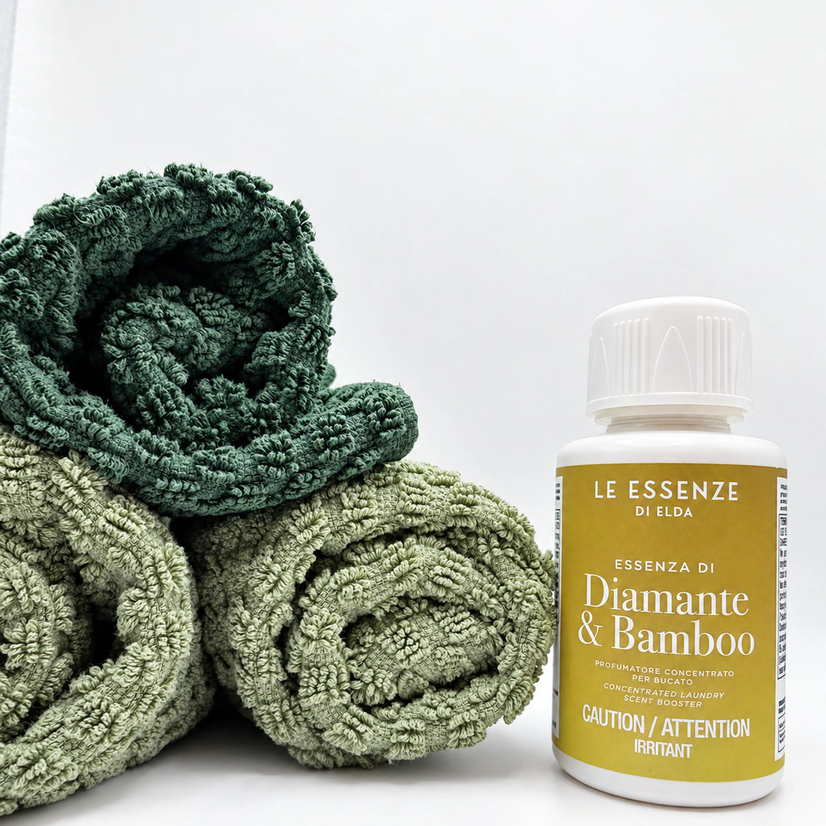 diamante Bamboo next to towels on white background 100ml bottle by aROMA Laundry.