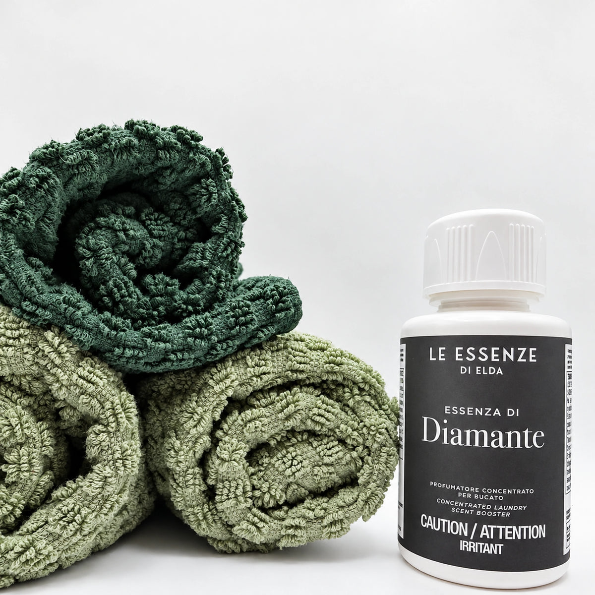 Diamante scent booster 100ml next to towels on white background by aROMA Laundry.
