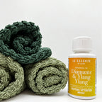 Diamante Ylang Ylang next to towels on white background in 100ml bottle by aROMA Laundry