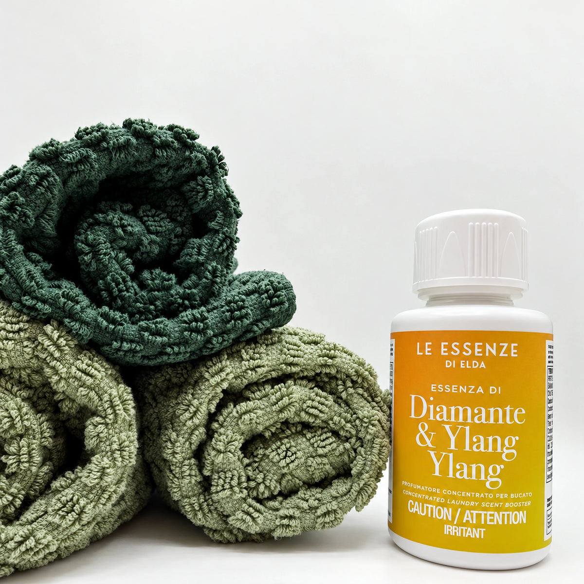 Diamante Ylang Ylang next to towels on white background in 100ml bottle by aROMA Laundry