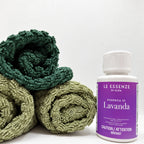 Lavanda scent booster next to towels on white background in 100ml bottle by aROMA Laundry