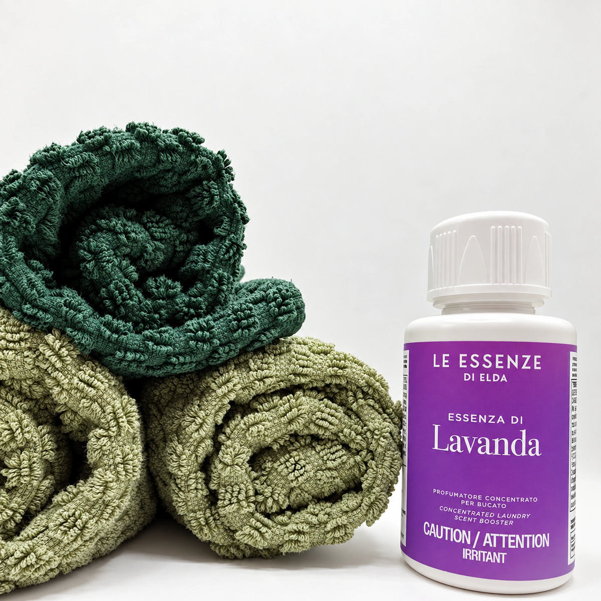 Lavanda scent booster next to towels on white background in 100ml bottle by aROMA Laundry